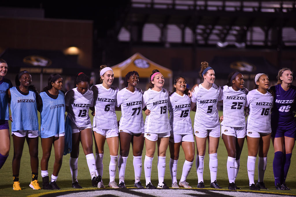Missouri soccer players line up to chant with fans